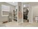 Spacious bathroom featuring open shelving, a full-length mirror, and entry to the walk-in closet at 5237 W Alta Mesa Ave, Laveen, AZ 85339