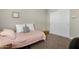 Bright bedroom showcasing a cozy bed, white closet doors and carpeted floors at 5237 W Alta Mesa Ave, Laveen, AZ 85339