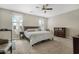 Cozy bedroom with neutral carpet, ceiling fan, and soft natural light, creating a relaxing atmosphere at 5237 W Alta Mesa Ave, Laveen, AZ 85339