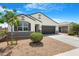 Inviting single-story home with tidy landscaping and a convenient two-car garage at 5237 W Alta Mesa Ave, Laveen, AZ 85339