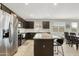 Well-lit kitchen featuring a central island with seating and ample counter space at 5237 W Alta Mesa Ave, Laveen, AZ 85339