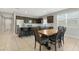 Open-concept kitchen with island seating, sleek appliances, and adjacent dining area at 5237 W Alta Mesa Ave, Laveen, AZ 85339