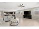 Open concept living room with dark cabinets, tile floors, neutral paint and a ceiling fan at 5237 W Alta Mesa Ave, Laveen, AZ 85339