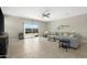 Bright living room with tile floors, ceiling fan and sliding glass doors leading to the outdoor patio at 5237 W Alta Mesa Ave, Laveen, AZ 85339