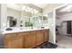 Bathroom featuring dual sinks and ample counter space with well lit mirrors at 553 W Hereford Dr, San Tan Valley, AZ 85143