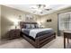 A well-lit bedroom with a wooden bed frame, two side tables, and a window provides a relaxing atmosphere at 553 W Hereford Dr, San Tan Valley, AZ 85143