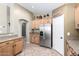 Well-lit kitchen offers ample cabinet space and stainless steel refrigerator at 553 W Hereford Dr, San Tan Valley, AZ 85143