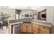 Open kitchen features granite counters, stainless steel appliances, and breakfast bar at 553 W Hereford Dr, San Tan Valley, AZ 85143