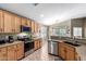 Well-equipped kitchen featuring granite countertops, stainless steel appliances, and ample cabinet space at 553 W Hereford Dr, San Tan Valley, AZ 85143