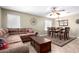 Comfortable living room with a large sectional sofa, a ceiling fan, and a dining area nearby at 553 W Hereford Dr, San Tan Valley, AZ 85143