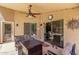 Relaxing covered patio featuring a ceiling fan and comfortable seating area, perfect for outdoor enjoyment at 553 W Hereford Dr, San Tan Valley, AZ 85143