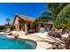 Backyard showcasing a private pool with lounge seating and a covered patio for outdoor dining at 553 W Hereford Dr, San Tan Valley, AZ 85143