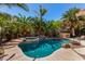 Private pool, palm trees and lush landscaping create a backyard oasis perfect for relaxation and entertainment at 553 W Hereford Dr, San Tan Valley, AZ 85143