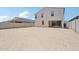 Backyard featuring the home's exterior with a large open dirt area at 5535 S 240Th Ln, Buckeye, AZ 85326