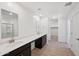 Bathroom with dual sinks, a long countertop, and a view into the walk-in closet at 5535 S 240Th Ln, Buckeye, AZ 85326