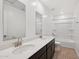 Bright bathroom featuring double sinks with modern fixtures and a shower-tub combo at 5535 S 240Th Ln, Buckeye, AZ 85326