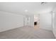 This bedroom offers neutral carpet, a walk-in closet, and a large window for ample light at 5535 S 240Th Ln, Buckeye, AZ 85326