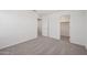 Carpeted spare bedroom with closet and doors at 5535 S 240Th Ln, Buckeye, AZ 85326