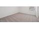 Empty bedroom featuring neutral carpeting and a window with blinds, offering a blank canvas at 5535 S 240Th Ln, Buckeye, AZ 85326