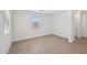 Bright, airy bedroom with wood-look tile floors, a large window, and neutral paint at 5535 S 240Th Ln, Buckeye, AZ 85326