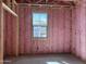Framed interior bedroom shows pink insulation, and a bright window at 5535 S 240Th Ln, Buckeye, AZ 85326