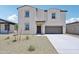 Charming two-story home featuring a neutral stucco exterior and a spacious two-car garage at 5535 S 240Th Ln, Buckeye, AZ 85326