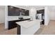 Modern kitchen features dark cabinets, stainless steel appliances, white countertops and stylish backsplash at 5535 S 240Th Ln, Buckeye, AZ 85326
