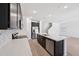 Bright kitchen boasts stainless appliances, dark cabinetry, and large island with a sink and dishwasher at 5535 S 240Th Ln, Buckeye, AZ 85326