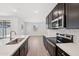 This kitchen has stainless steel appliances, dark wood cabinets, white backsplash and countertops at 5535 S 240Th Ln, Buckeye, AZ 85326