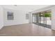 Open living space with sliding glass doors, tile floors, and ample natural light at 5535 S 240Th Ln, Buckeye, AZ 85326