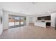 Open-concept living room and kitchen featuring modern tile flooring and large glass patio doors at 5535 S 240Th Ln, Buckeye, AZ 85326