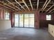 Spacious, unfinished room, has exposed beams and a sliding glass door to patio at 5535 S 240Th Ln, Buckeye, AZ 85326