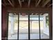 Sliding glass doors offer a view of the backyard from an unfinished patio at 5535 S 240Th Ln, Buckeye, AZ 85326
