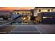 Modern home with a pool, pickleball court, and landscaped backyard with sunset views at 5814 E Camelback Rd, Phoenix, AZ 85018