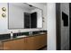 Modern bathroom with double vanity, large mirror, and stylish fixtures at 5814 E Camelback Rd, Phoenix, AZ 85018