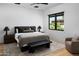 Modern bedroom with a king bed, black framed windows, and stylish decor and furnishings at 5814 E Camelback Rd, Phoenix, AZ 85018