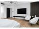 Modern bedroom showcasing a mounted TV, sleek lighting, and stylish decor for comfortable living at 5814 E Camelback Rd, Phoenix, AZ 85018