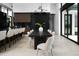 Modern dining area with seating for 8, a wine cellar and view of the outdoor pool at 5814 E Camelback Rd, Phoenix, AZ 85018