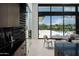 Modern dining area with a wine cellar and view of the outdoor pool at 5814 E Camelback Rd, Phoenix, AZ 85018