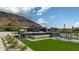 Modern luxury home with a pool and basketball court against a mountain backdrop at 5814 E Camelback Rd, Phoenix, AZ 85018
