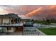 Modern home with an infinity pool, outdoor kitchen and basketball court at sunset at 5814 E Camelback Rd, Phoenix, AZ 85018