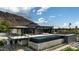 Modern luxury home with sleek design, pool, and desert mountain backdrop at 5814 E Camelback Rd, Phoenix, AZ 85018