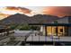 Modern home with a balcony overlooking the mountains, desert landscaping, and a minimalist design at 5814 E Camelback Rd, Phoenix, AZ 85018
