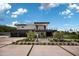 Contemporary home with stylish landscaping, driveway, and a multi-car garage at 5814 E Camelback Rd, Phoenix, AZ 85018