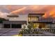 Beautiful modern home with a spacious driveway, dark garage doors, and manicured landscaping at 5814 E Camelback Rd, Phoenix, AZ 85018