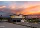 Beautiful modern home with a spacious driveway, dark garage doors, and manicured landscaping at 5814 E Camelback Rd, Phoenix, AZ 85018