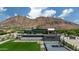 Grand modern home with a luxurious pool and basketball court set against a mountain backdrop at 5814 E Camelback Rd, Phoenix, AZ 85018