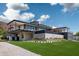 Expansive modern home with sleek lines, a private pool, and lush green landscaping at 5814 E Camelback Rd, Phoenix, AZ 85018
