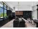 Sleek modern kitchen boasts black marble island, high-end appliances, and open dining area with natural light at 5814 E Camelback Rd, Phoenix, AZ 85018