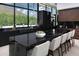 Modern kitchen features black marble countertops, sleek cabinetry, and a stunning view of the mountains at 5814 E Camelback Rd, Phoenix, AZ 85018